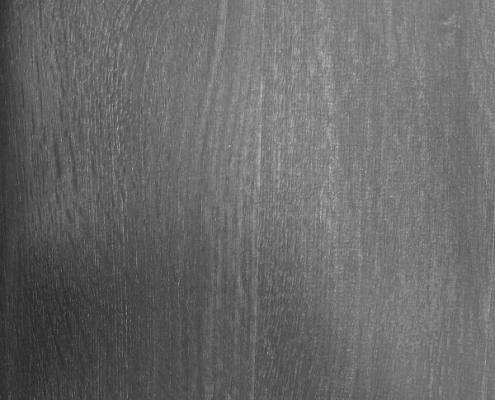 Walnut wood grain is admired for its rich, deep color and elegant patterns, often featuring shades of dark brown, chocolate, and purplish tones.